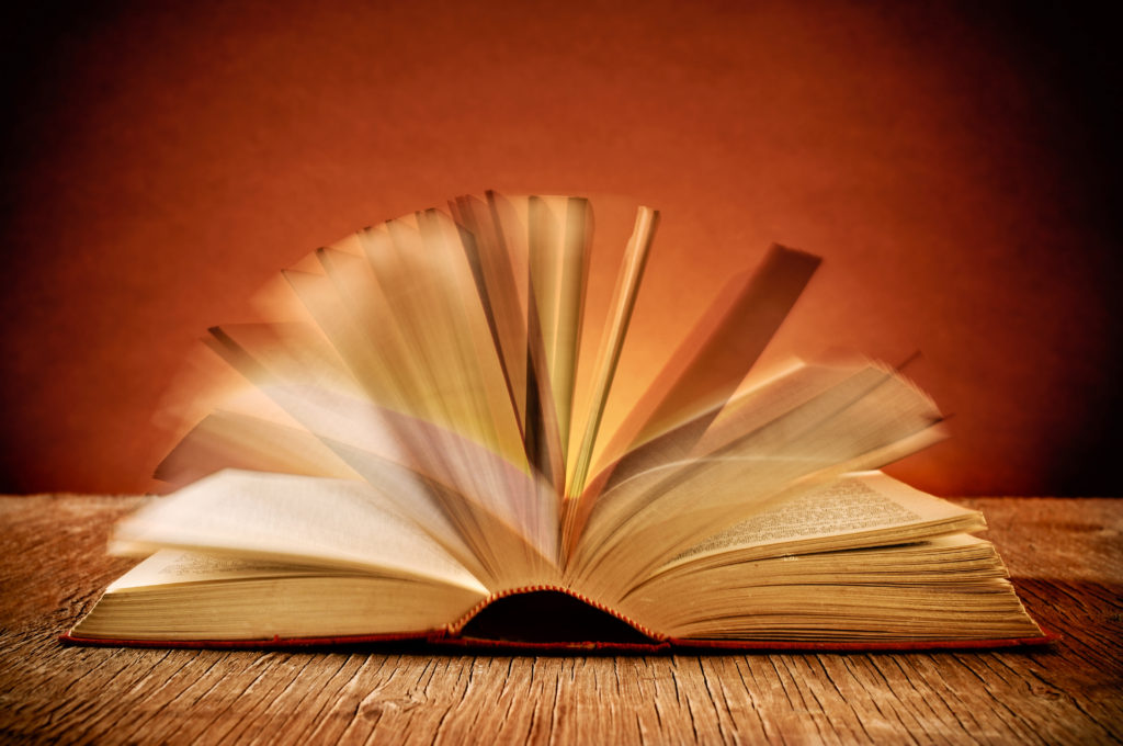 open old book on a rustic wooden table