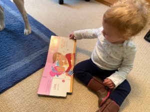 Baby reads "Nita's First Signs"