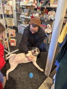 Charm City books co-owner Joe with shop dog Winter
